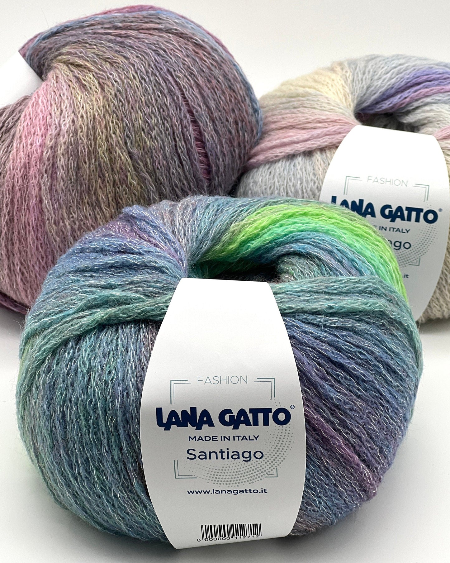 Three skeins of colorful yarn with 'Lana Gatto' labels on a white background