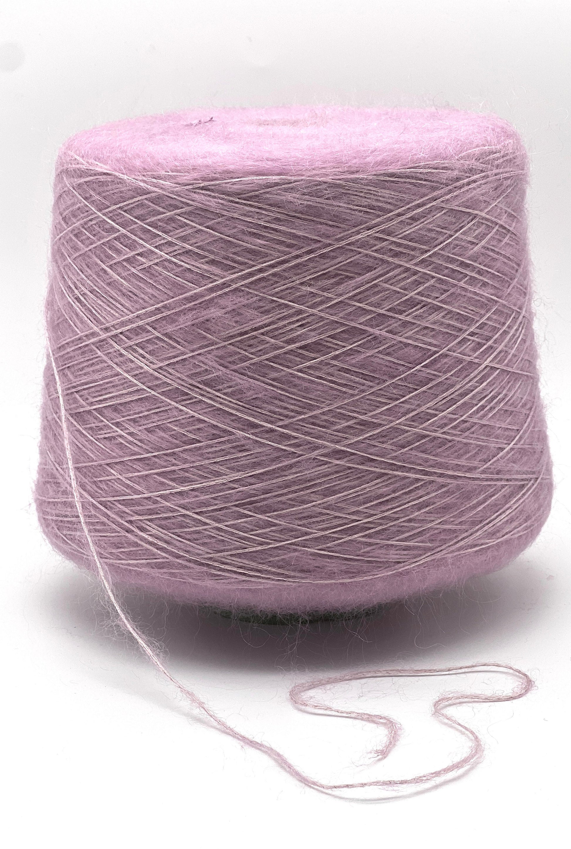 Ball of pink yarn on a white background