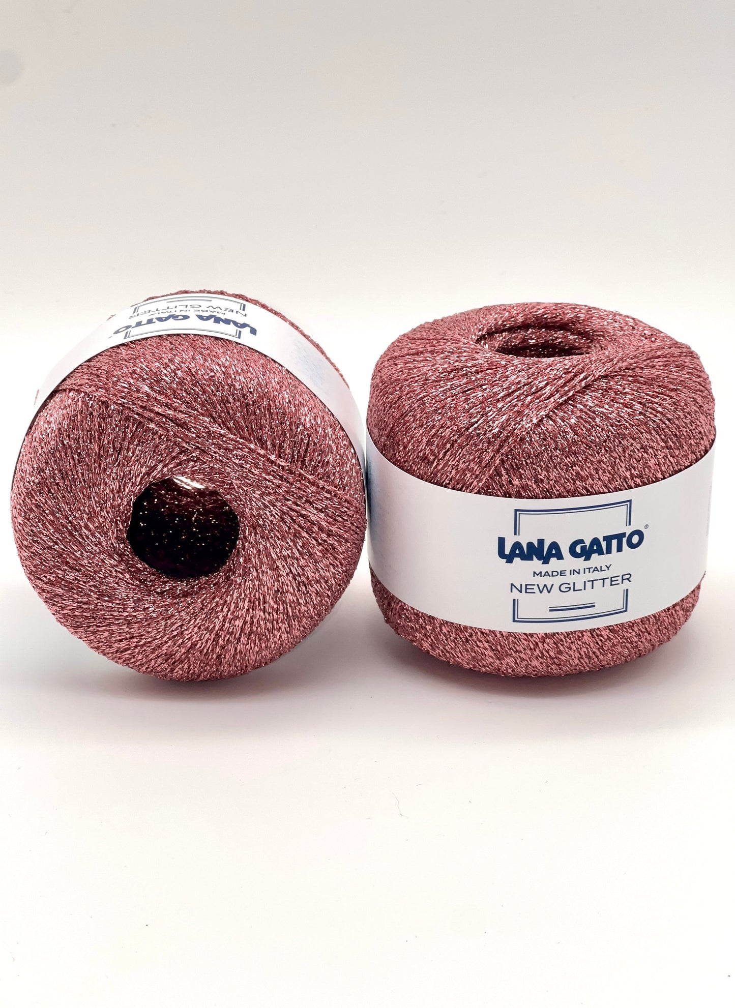 Two skeins of pink yarn with 'Lana Gatto' labels on a white background