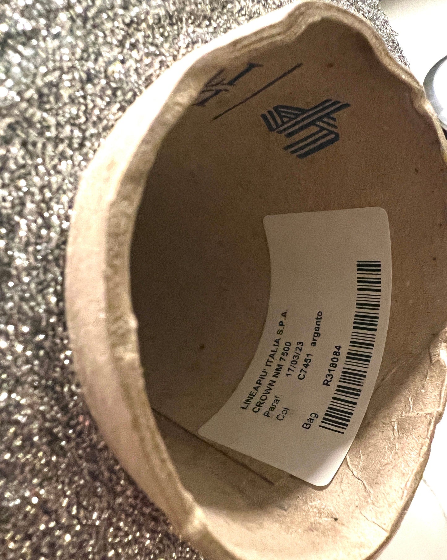 Cardboard box with a label and barcode on a textured surface