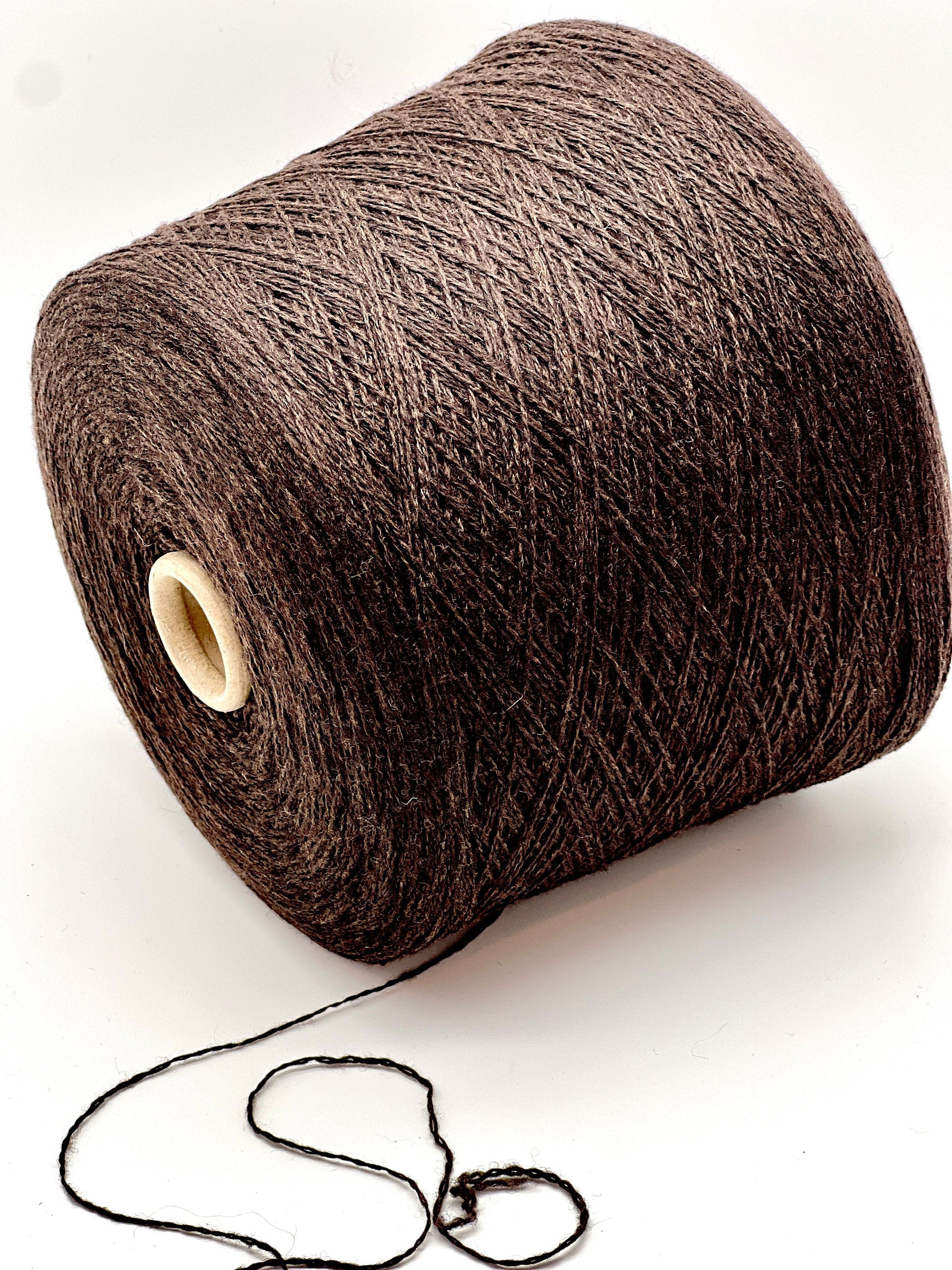 Brown yarn spool on a white background