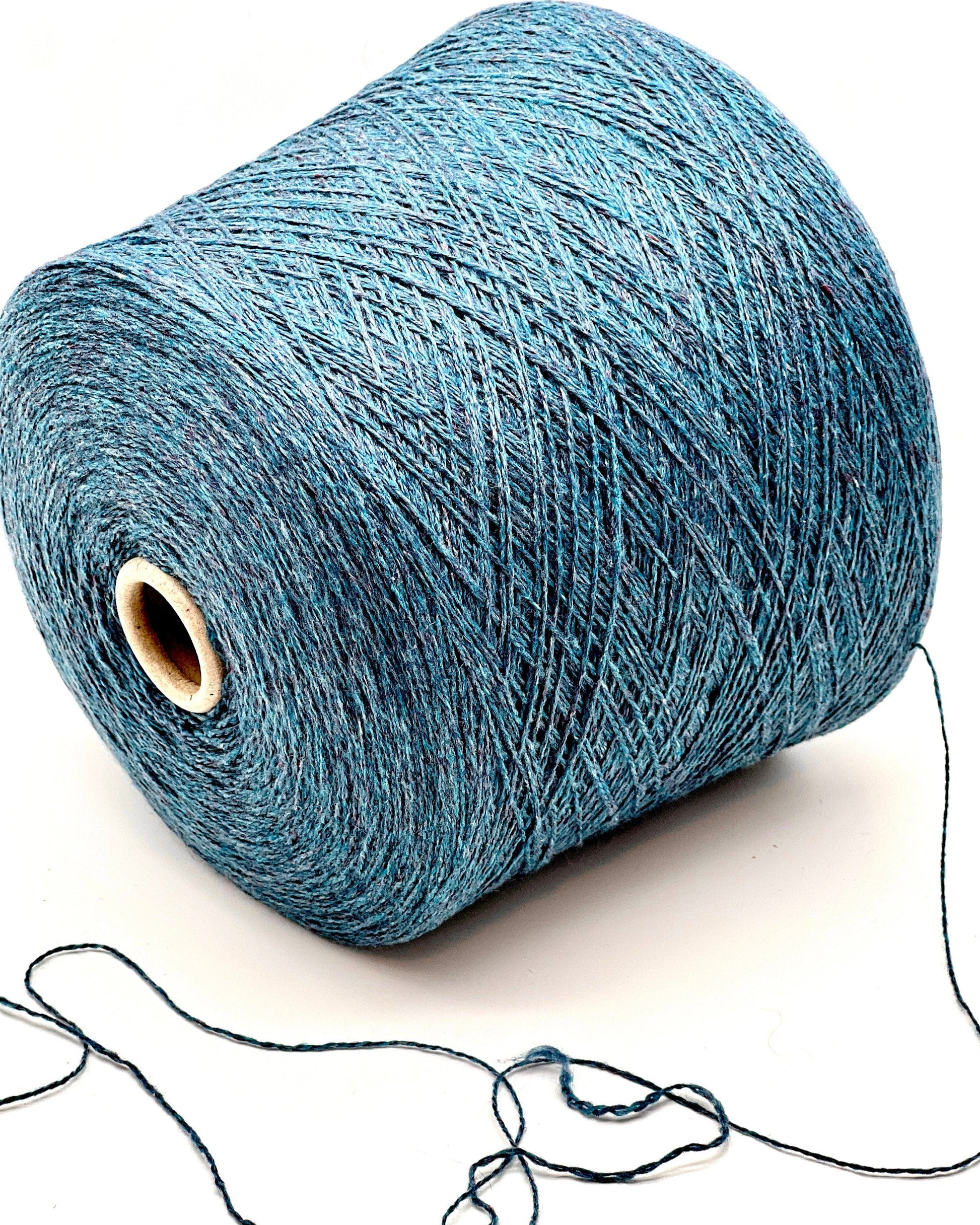 Blue yarn spool on a white background