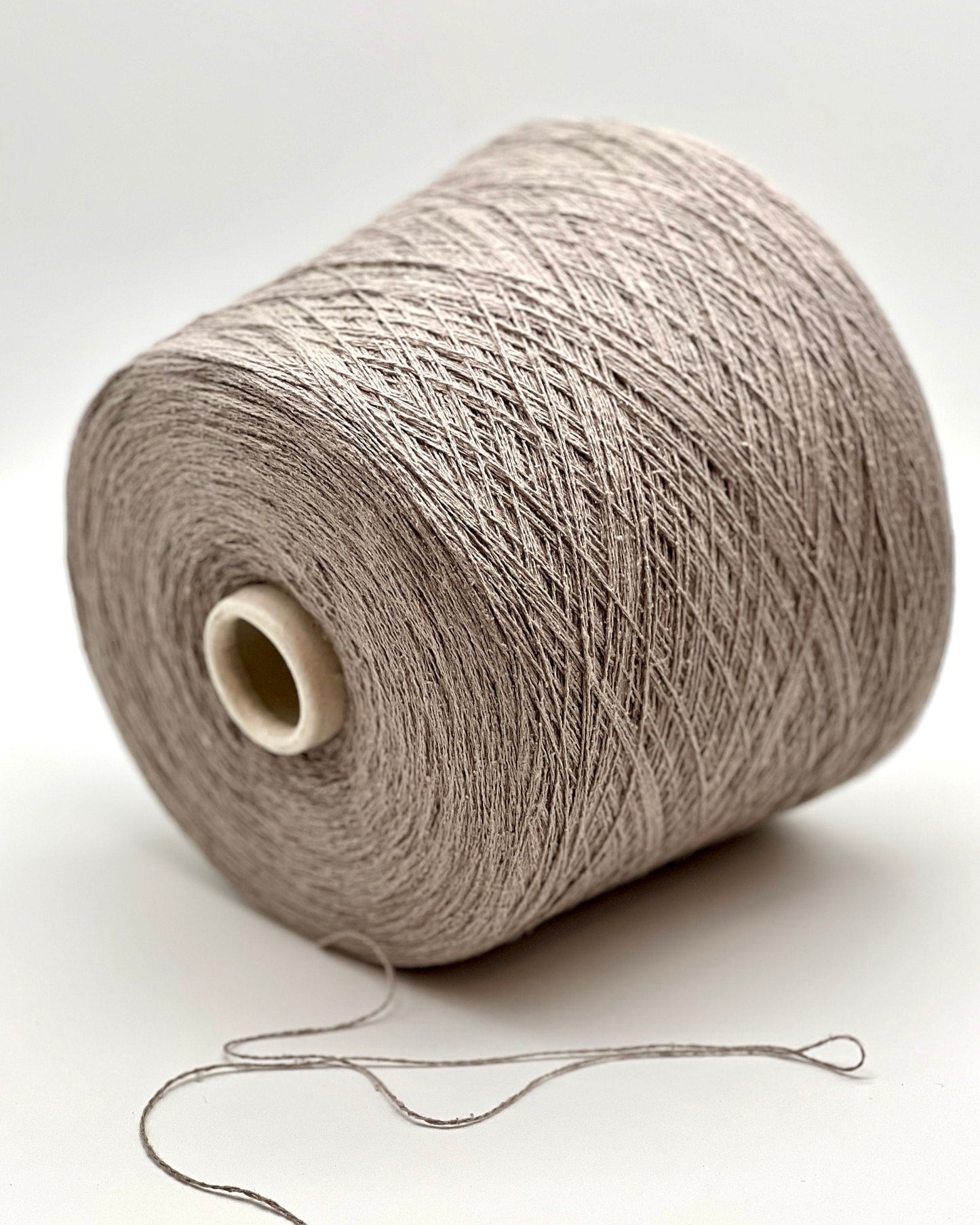 Spool of gray yarn on a white background