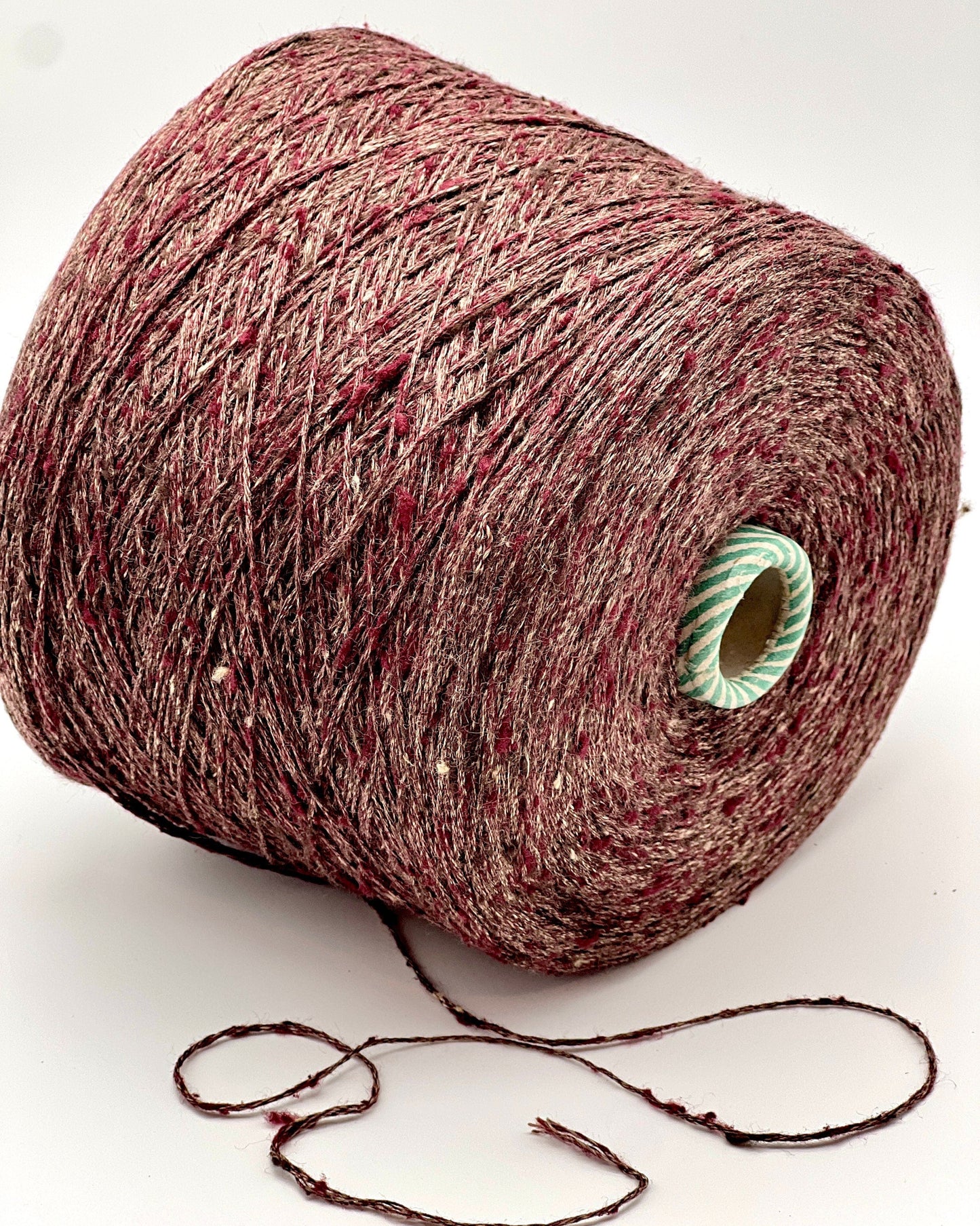 Spool of red yarn on a white background