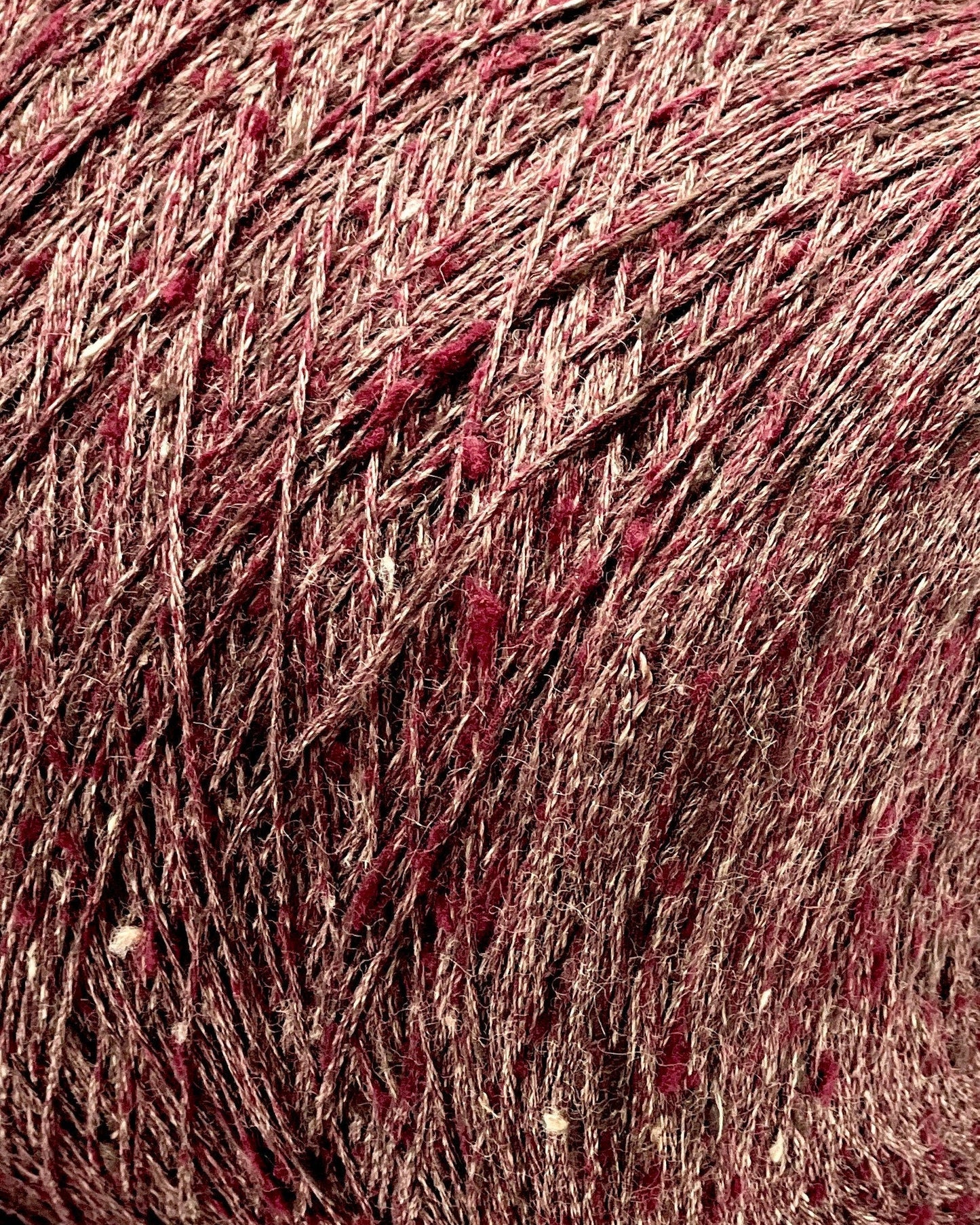Close-up of a ball of red yarn with speckles
