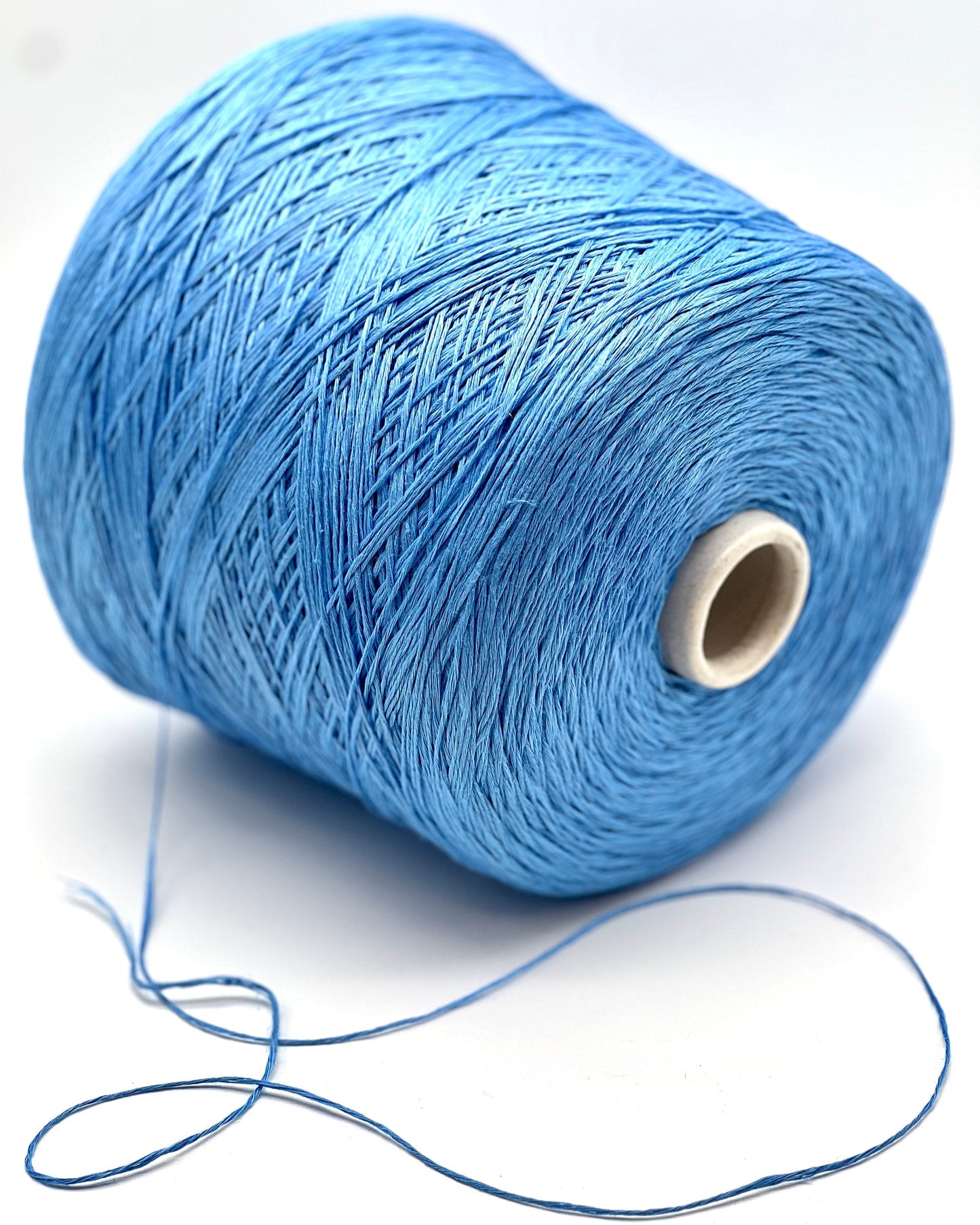 Blue spool of thread on a white background