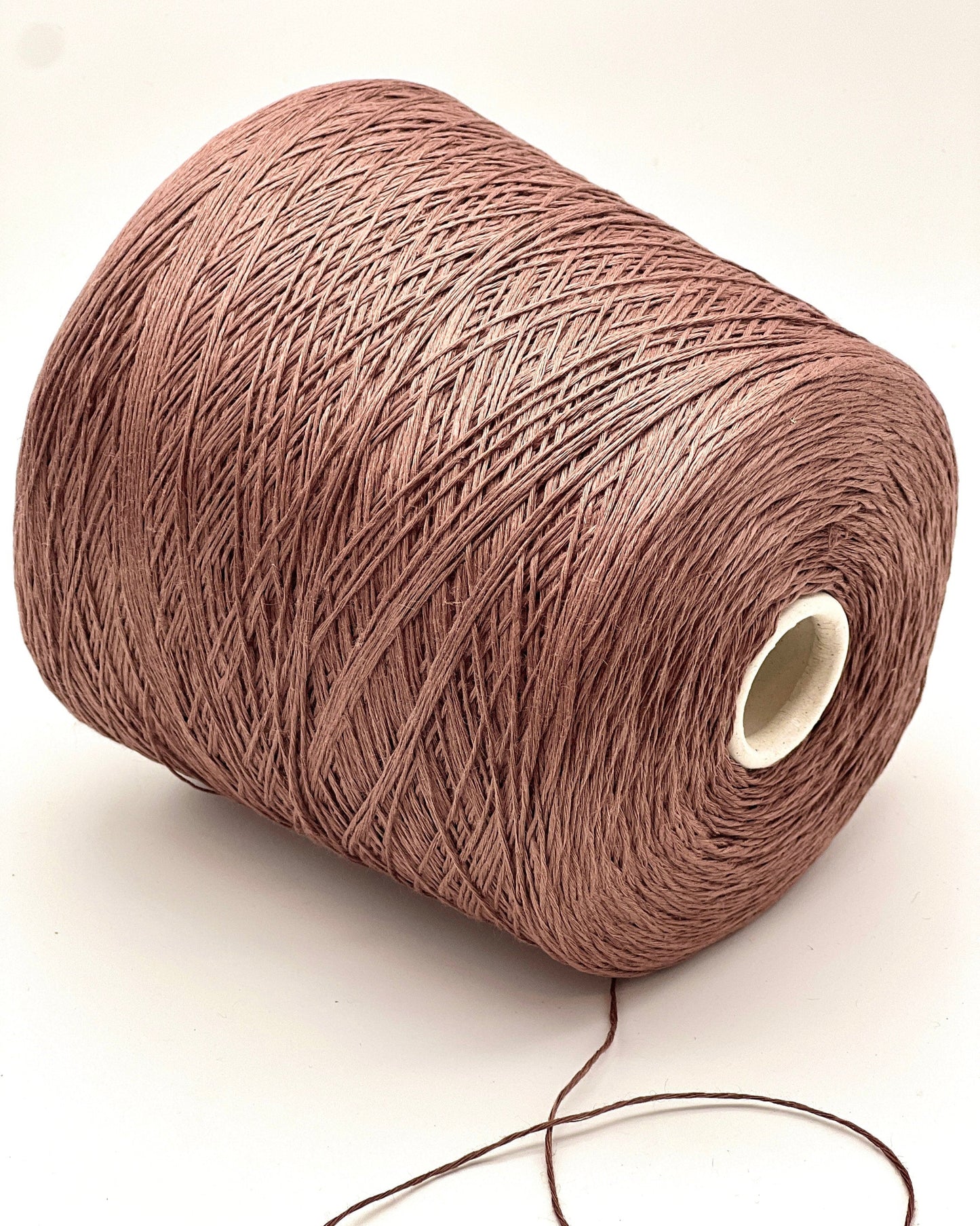 Brown spool of yarn on a white background