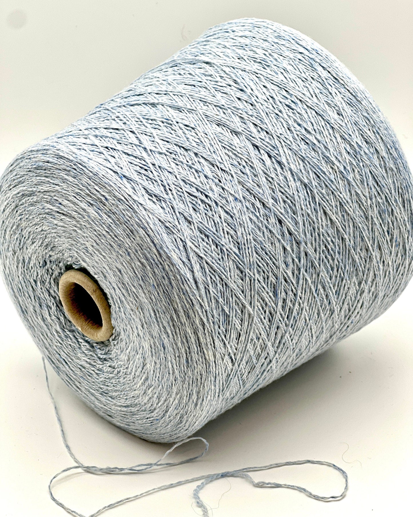 Spool of gray yarn on a white background