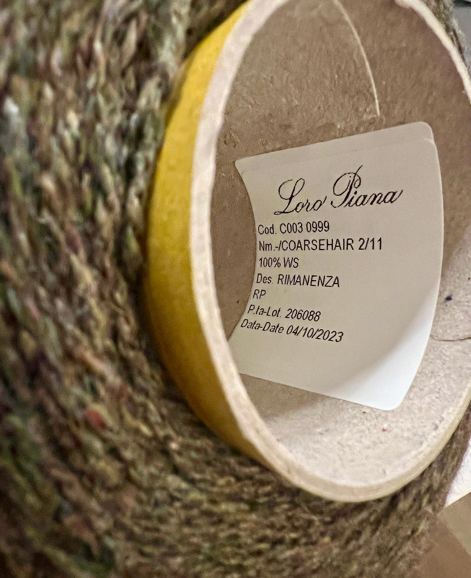 Close-up of a Loro Piana label on a textured fabric background