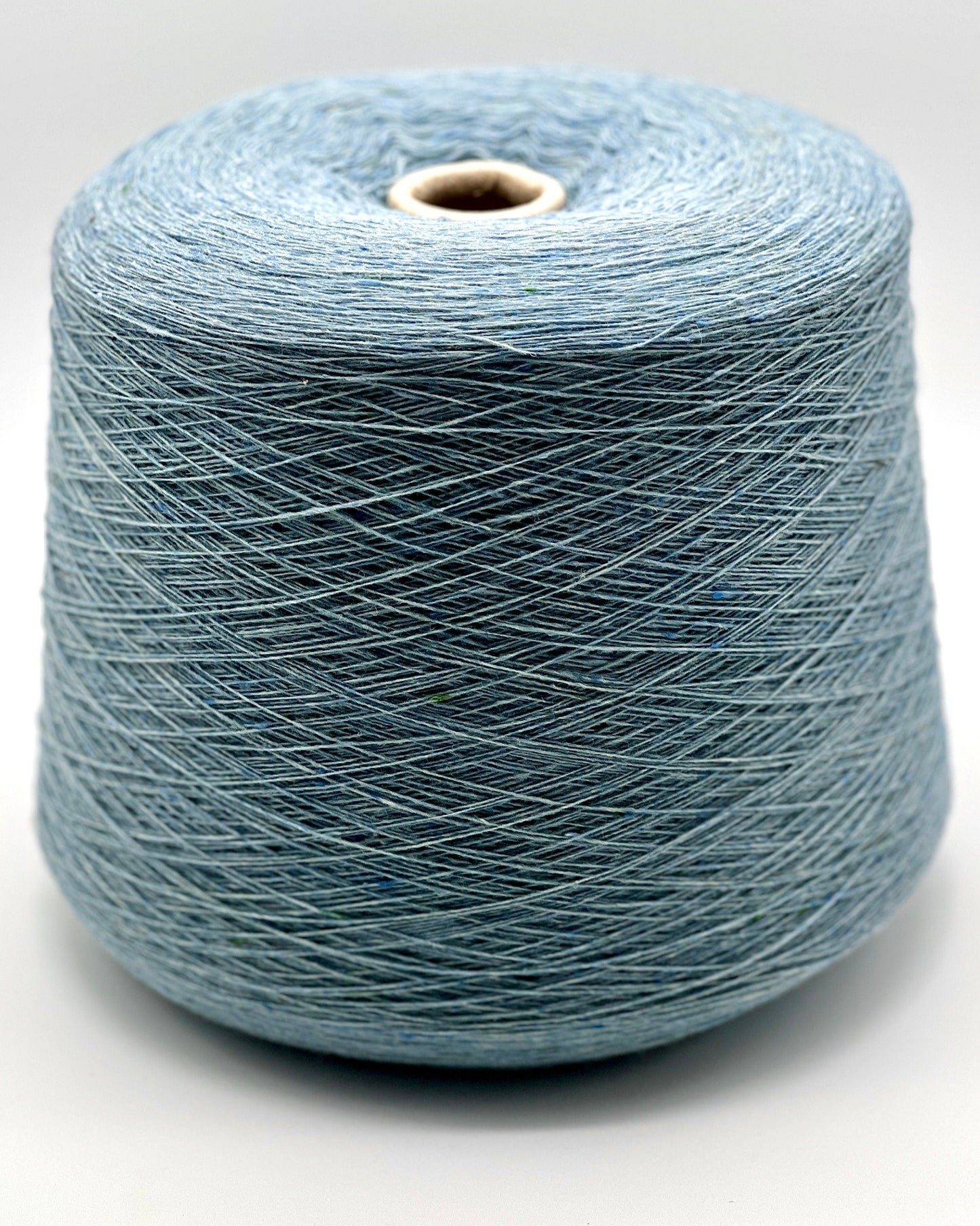 Blue spool of yarn on a white background