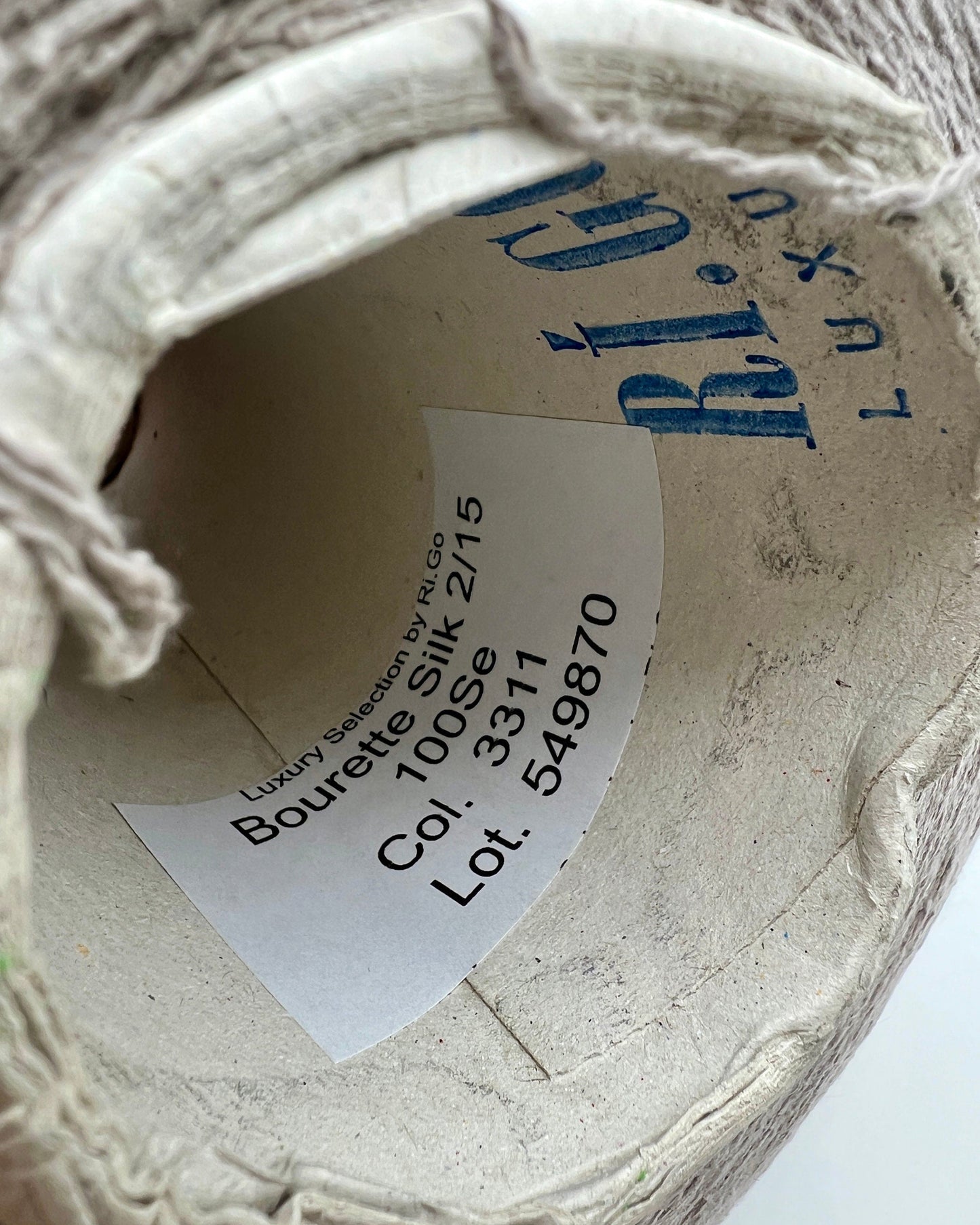 Close-up of a shoe with a label inside, featuring text and numbers.