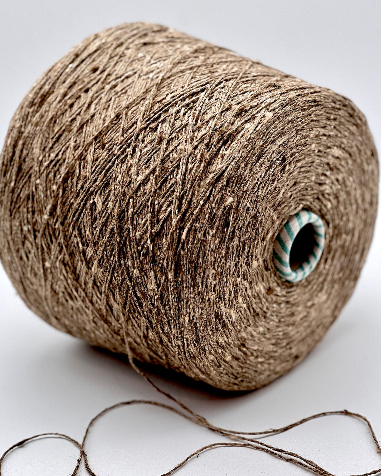 Spool of brown twine on a white background