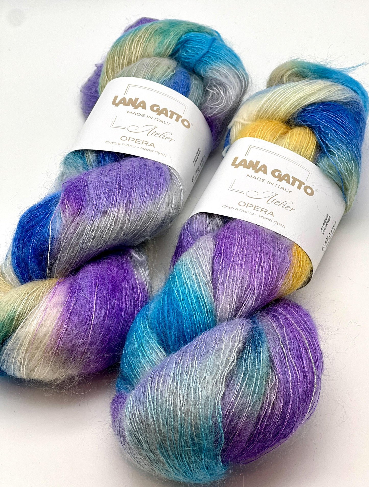 Three skeins of colorful yarn with 'Lana Gatto' labels on a white background