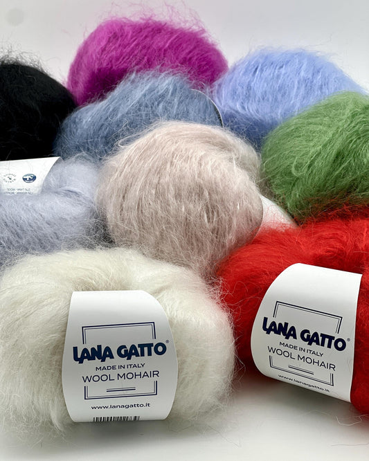 Balls of colorful wool mohair yarn with 'Lana Gatto' labels on a white background