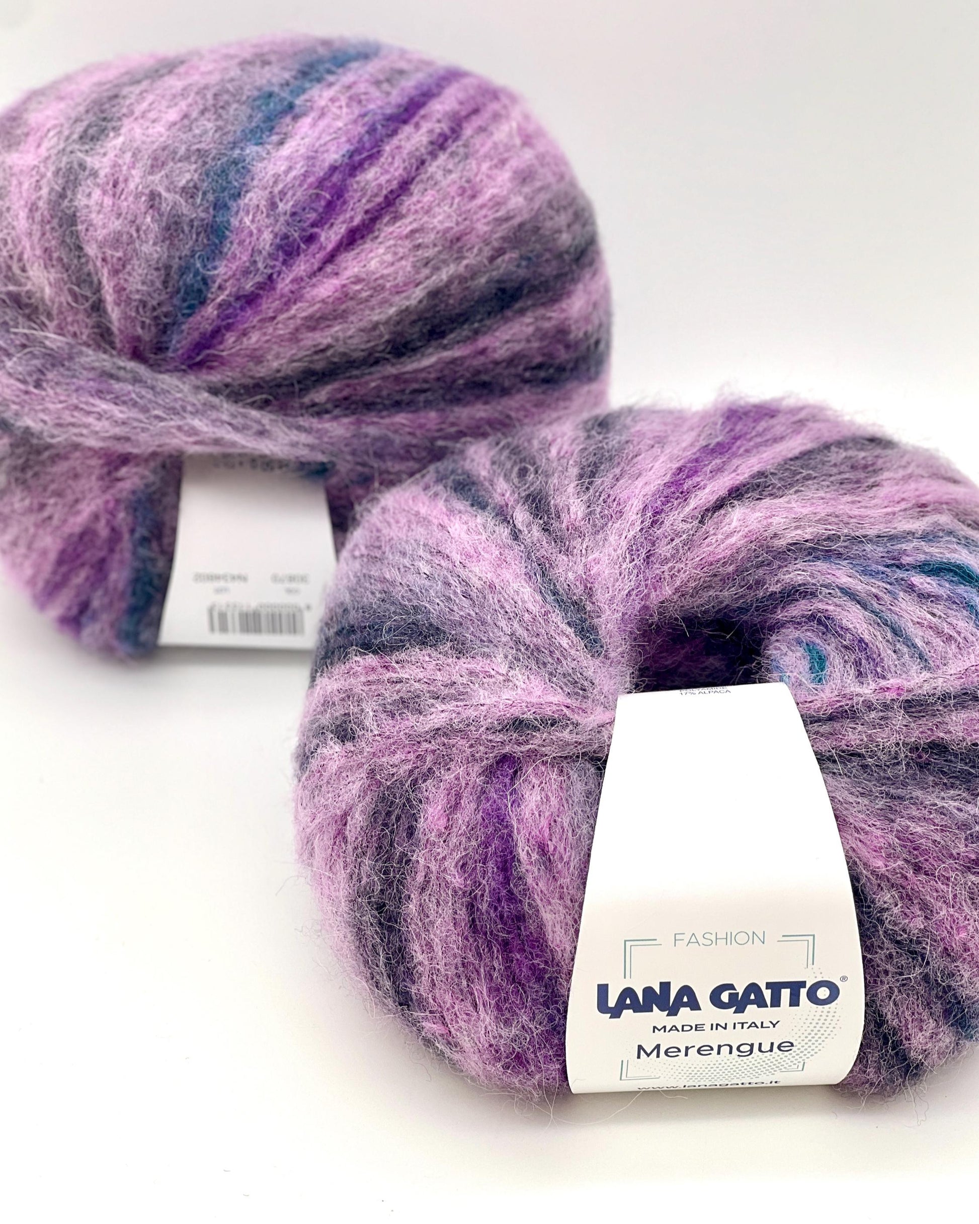 Two balls of purple and blue yarn with 'Lana Grossa' labels on a white background