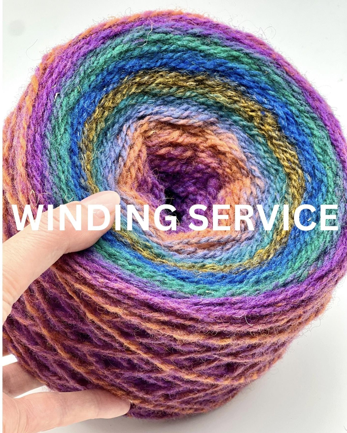 Colorful yarn wound into a center-pull cake, demonstrating the iDOKNiT custom winding service.