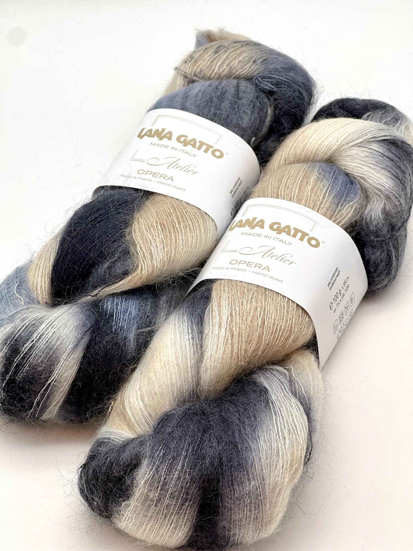Two skeins of yarn with gradient colors and 'Lana Gatto' labels on a white background