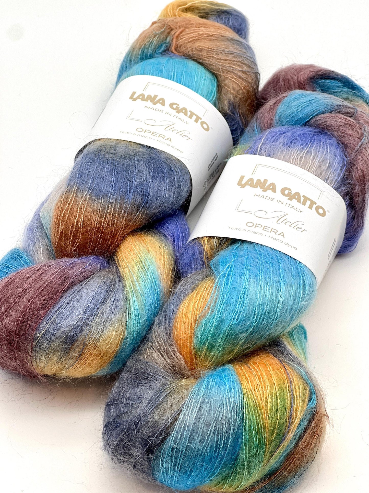 Three skeins of colorful yarn with 'Lana Grossa' labels on a white background