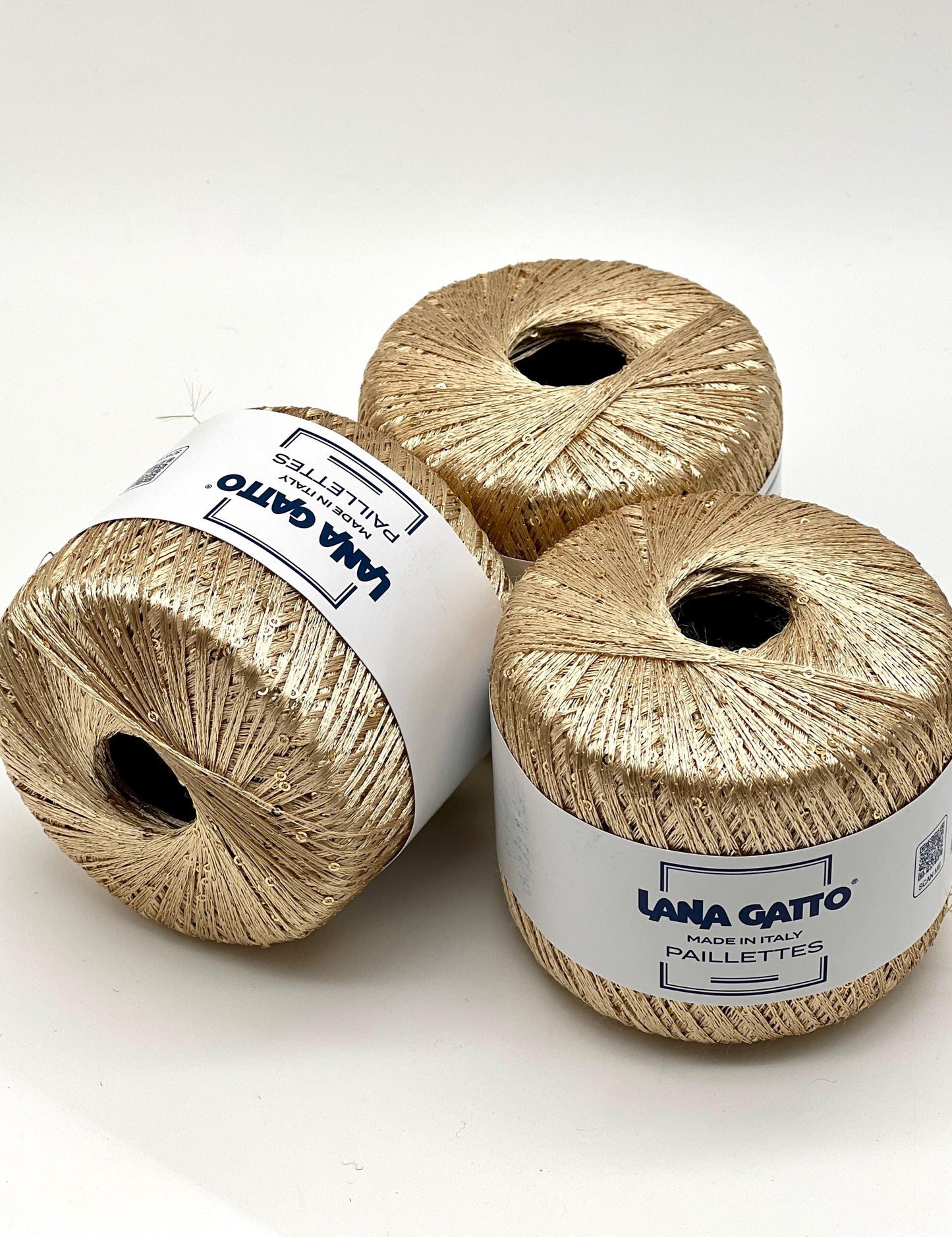Lana Gatto Paillettes yarn in shimmering pastel tones, with delicate 2mm sequins, lightweight polyester yarn ideal for adding sparkle to knit or crochet projects. Made in Italy. 30784 light gold color.