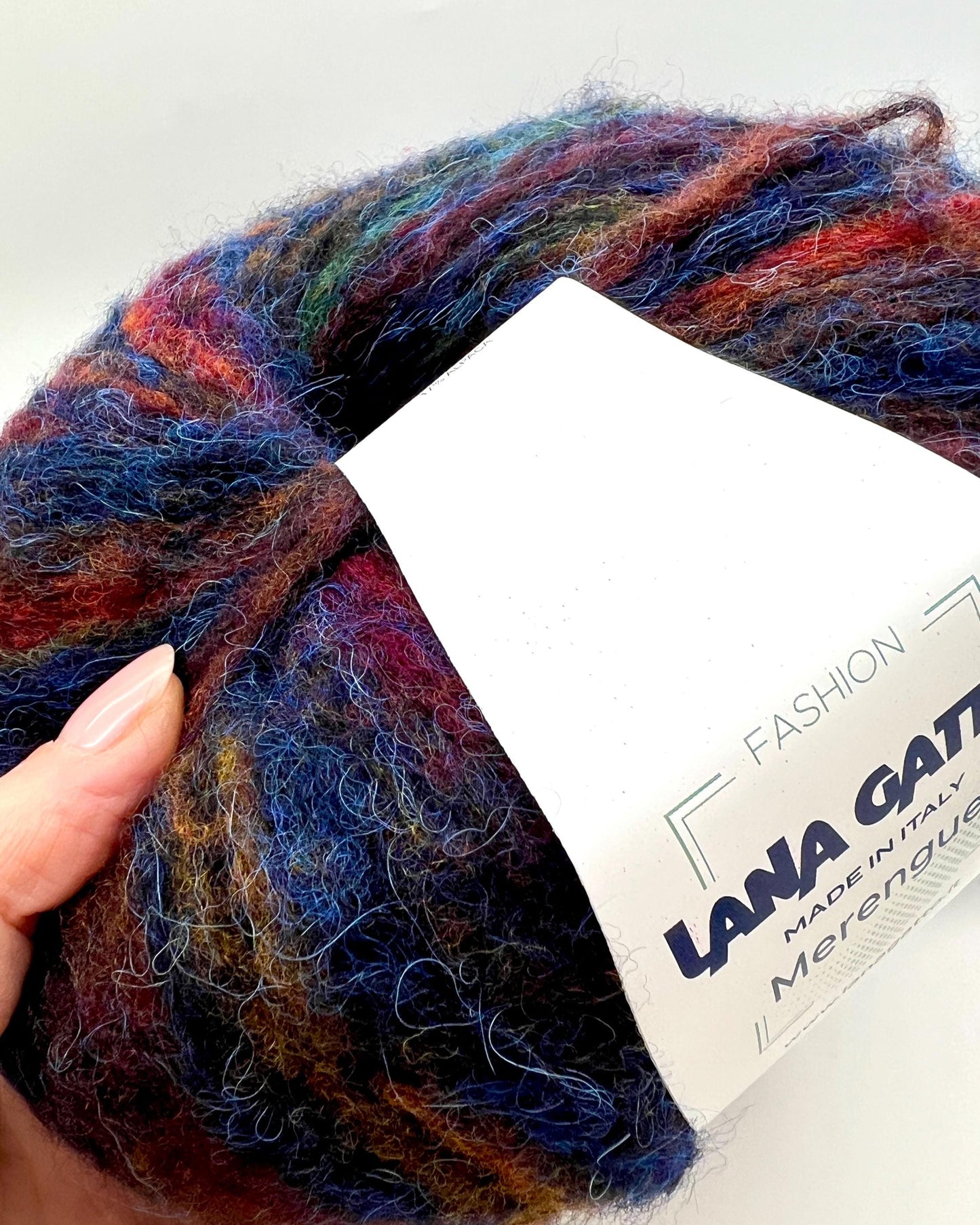Multicolored yarn ball with a Lana Grossa label on a white background