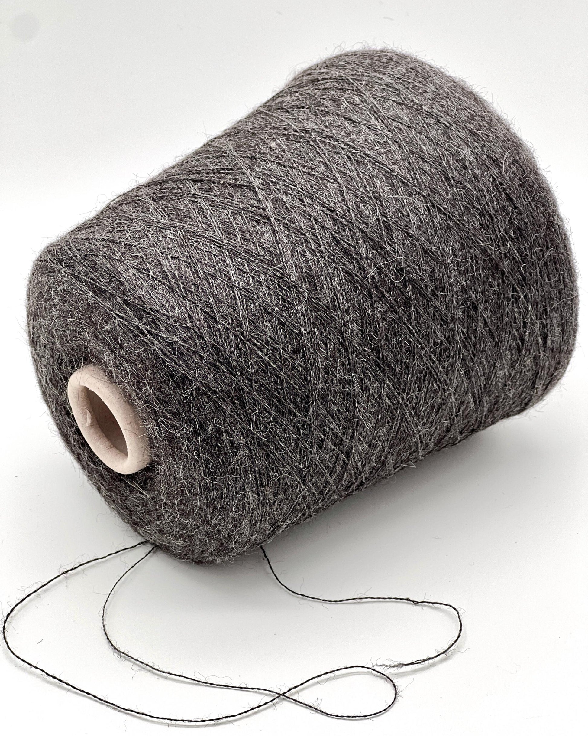 Spool of gray yarn on a white background
