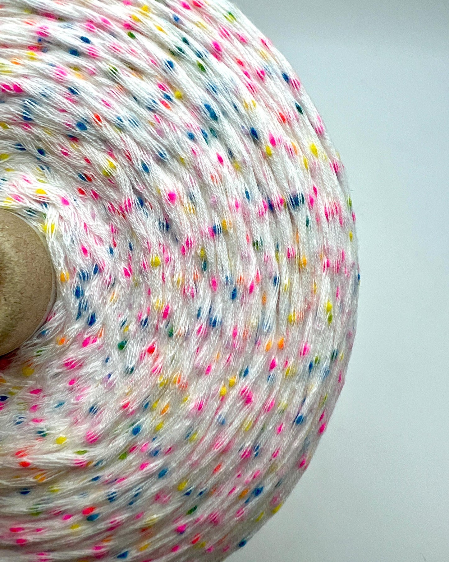 Spool of colorful string on a white background