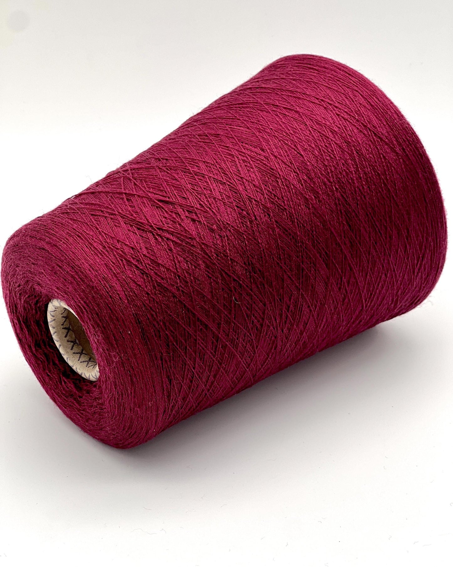 Red yarn roll on a white background