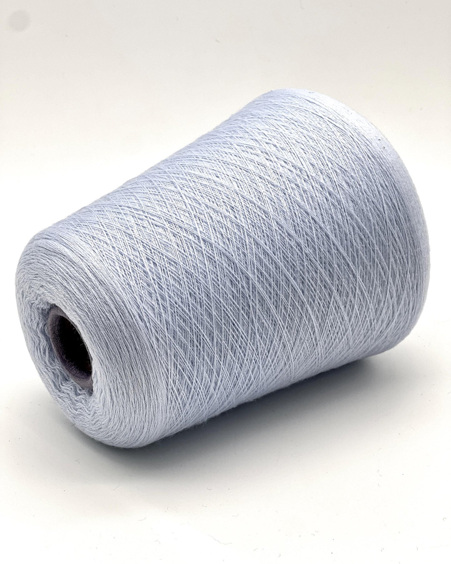 Roll of light blue yarn on a white background