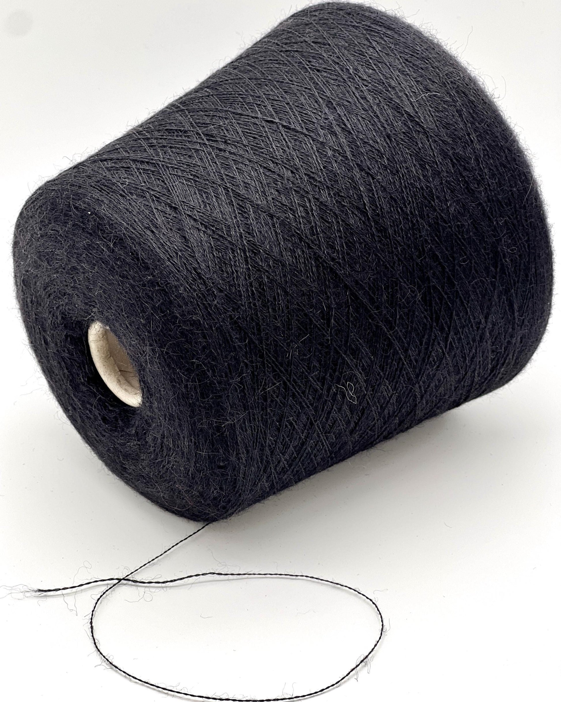 Spool of dark gray yarn on a white background