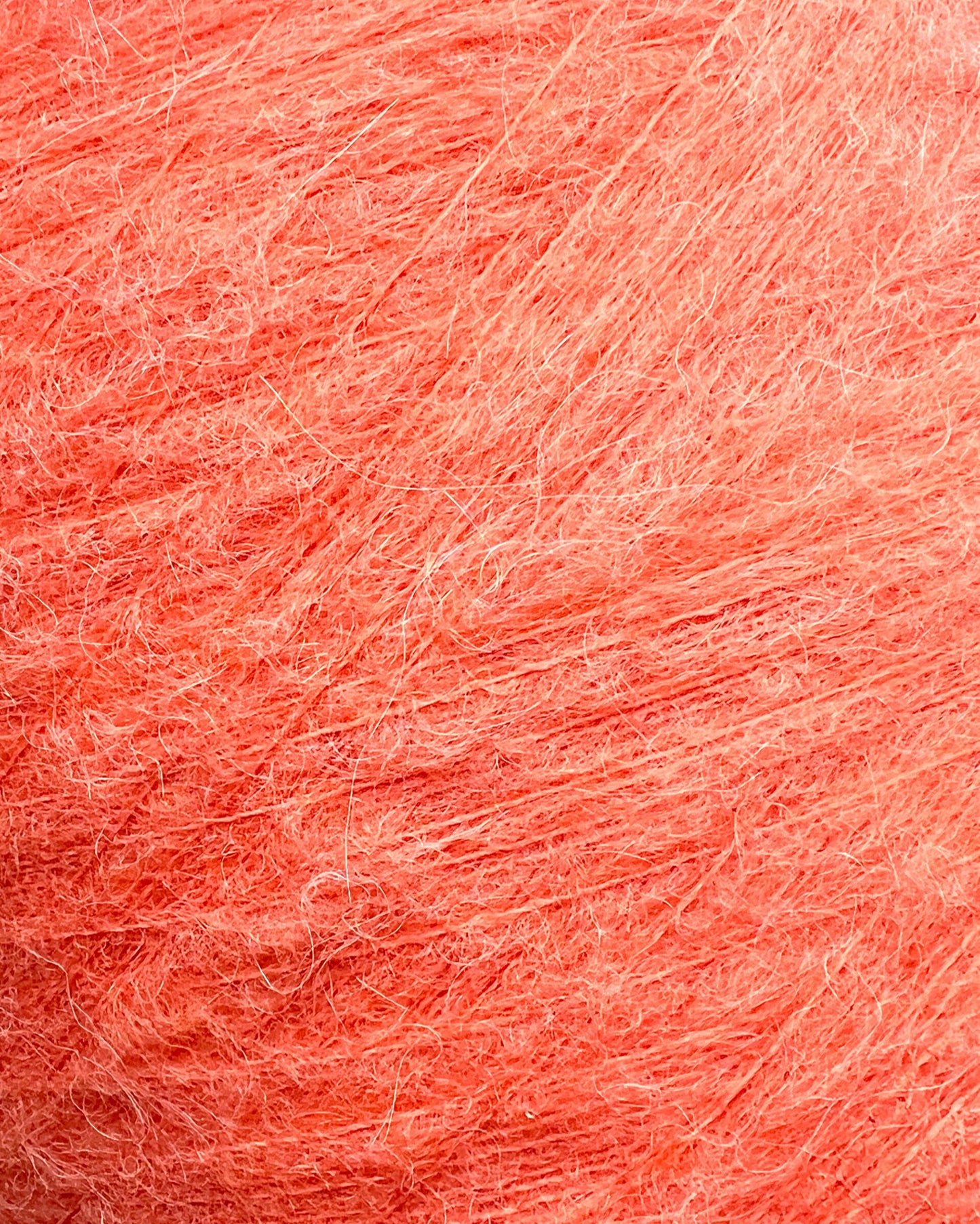 Close-up of pinkish-orange yarn texture