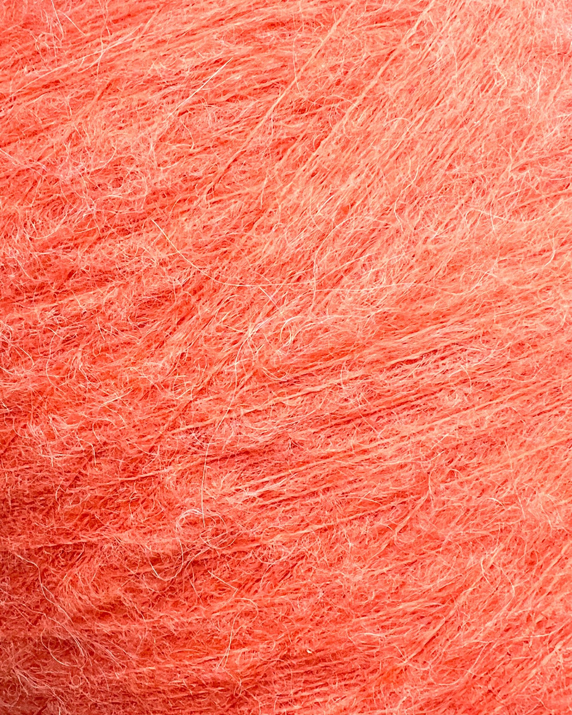 Close-up of pinkish-orange yarn texture