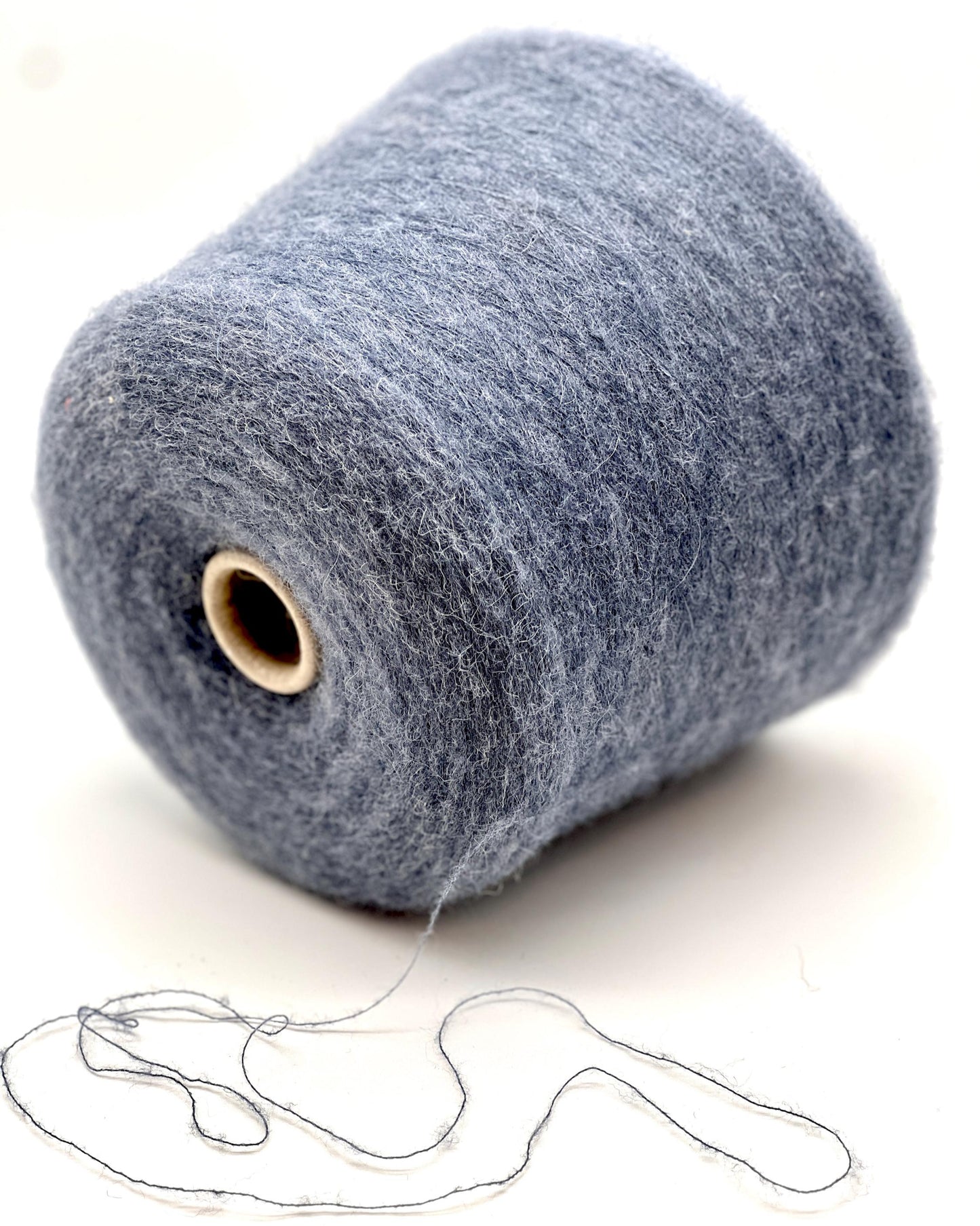 Large spool of gray yarn with a small amount of yarn extended on a white background