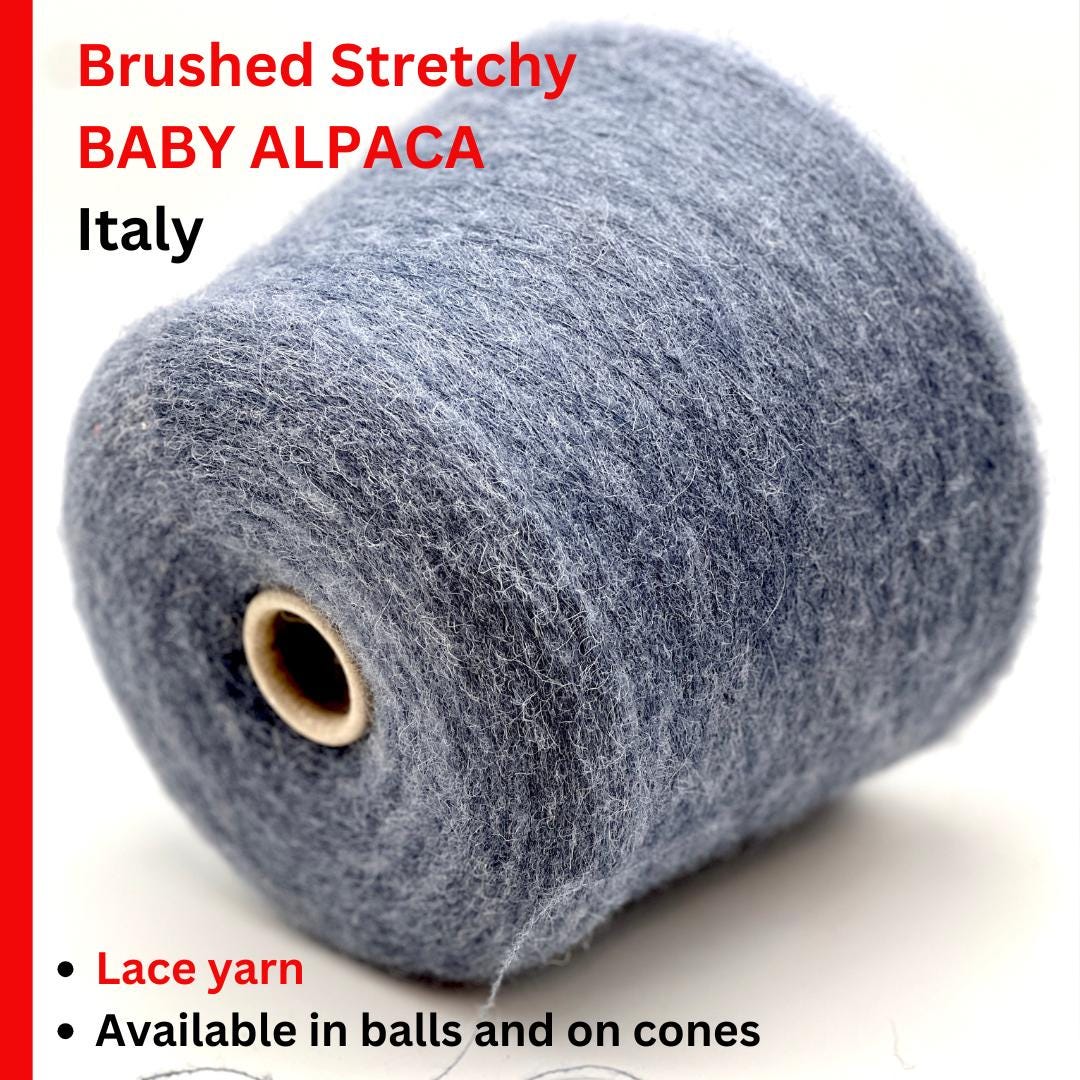 Spool of brushed stretchy baby alpaca yarn with text on a white background