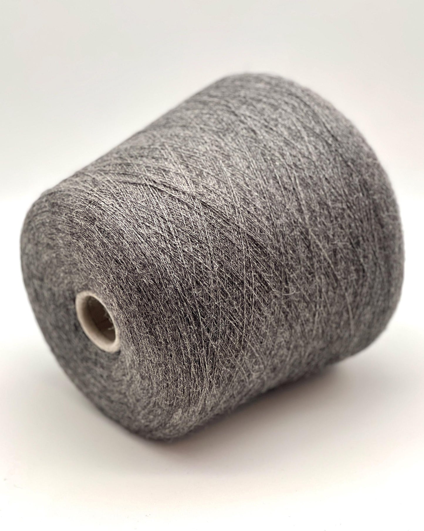Spool of gray yarn on a white background