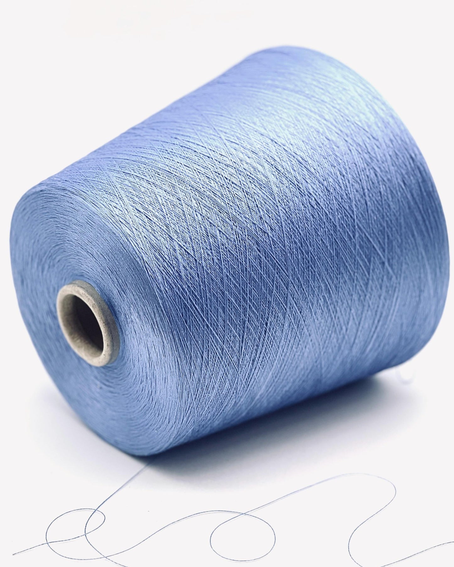 Blue spool of yarn on a white background