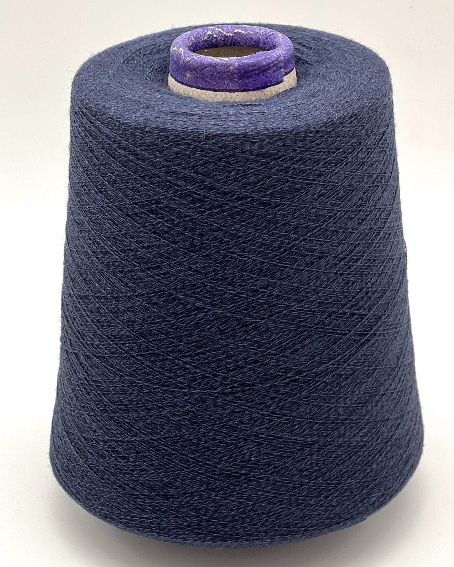 Spool of blue yarn on a white background