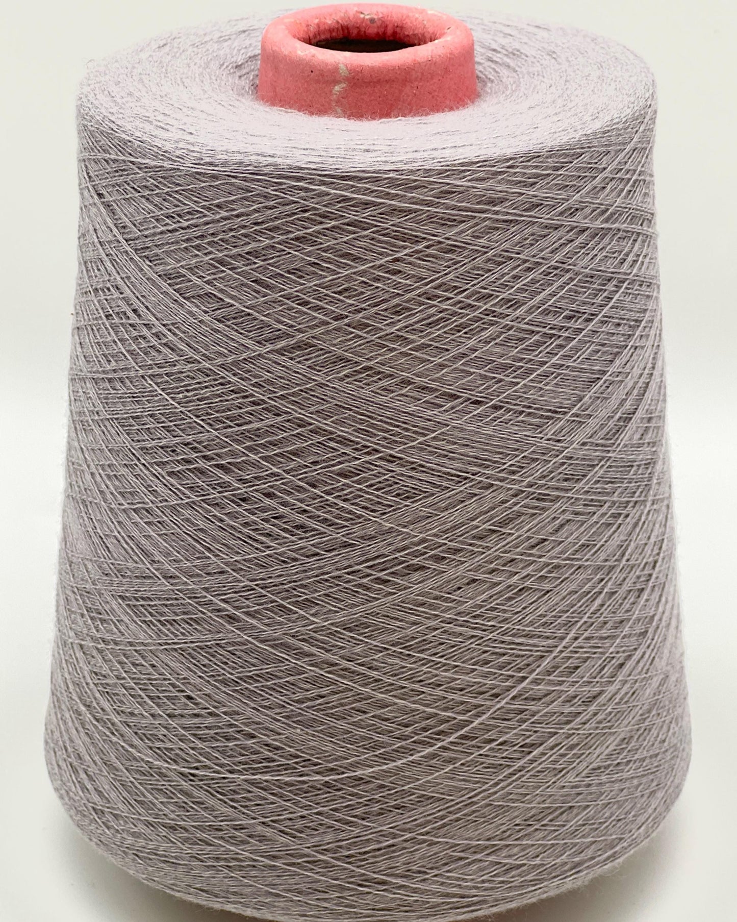 Spool of gray yarn on a white background