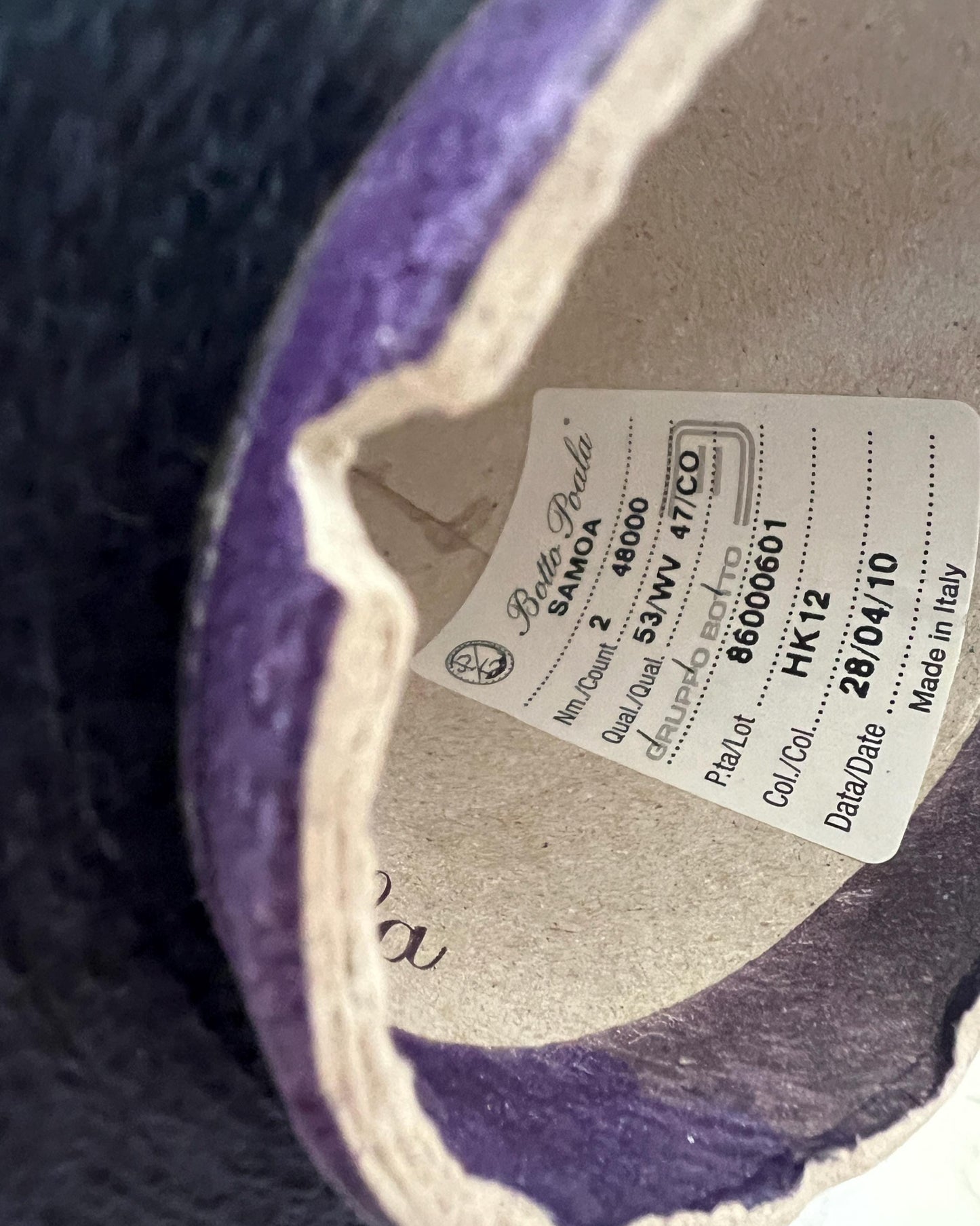 Close-up of a label inside a purple shoe with brand details.