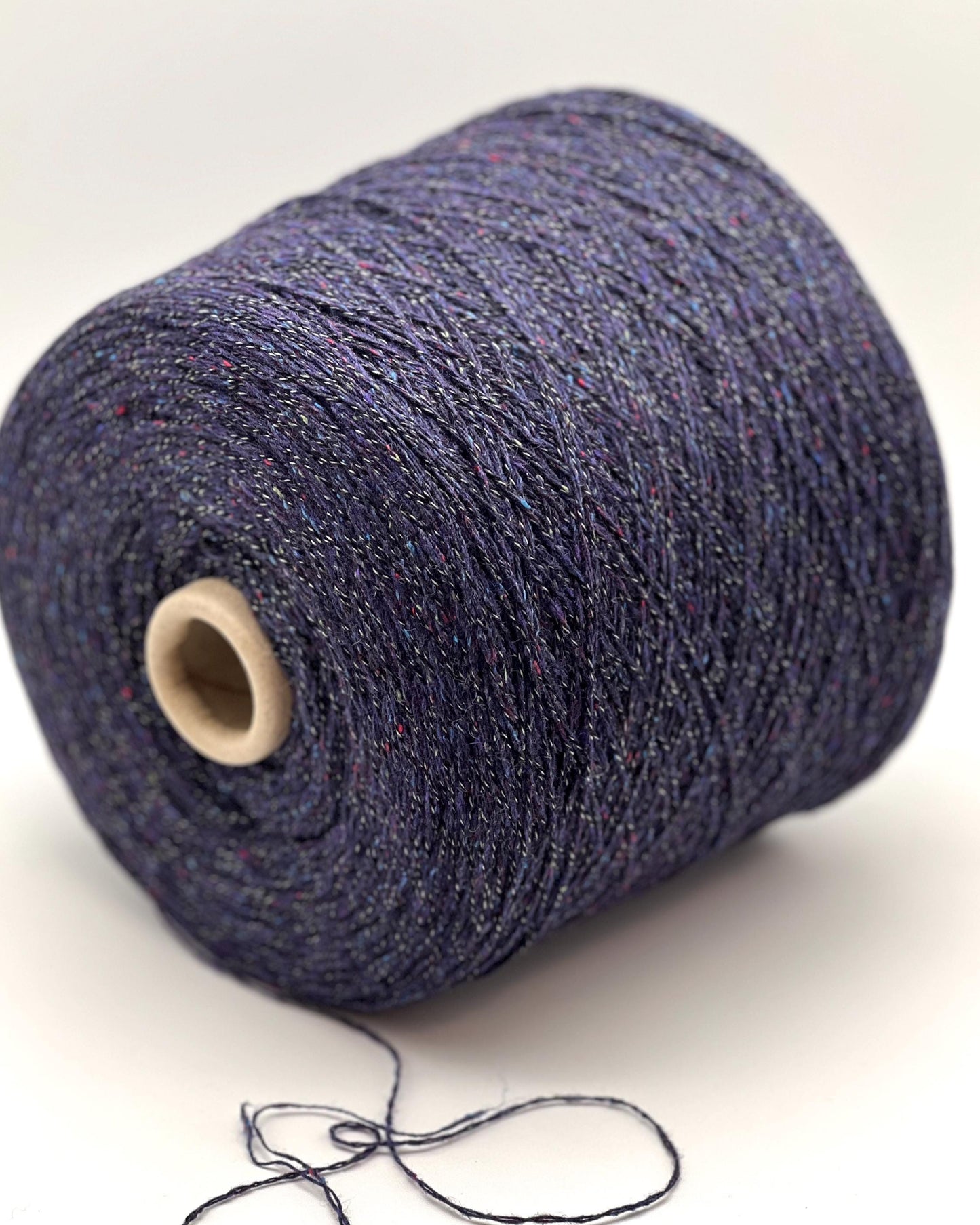 Spool of blue yarn on a white background