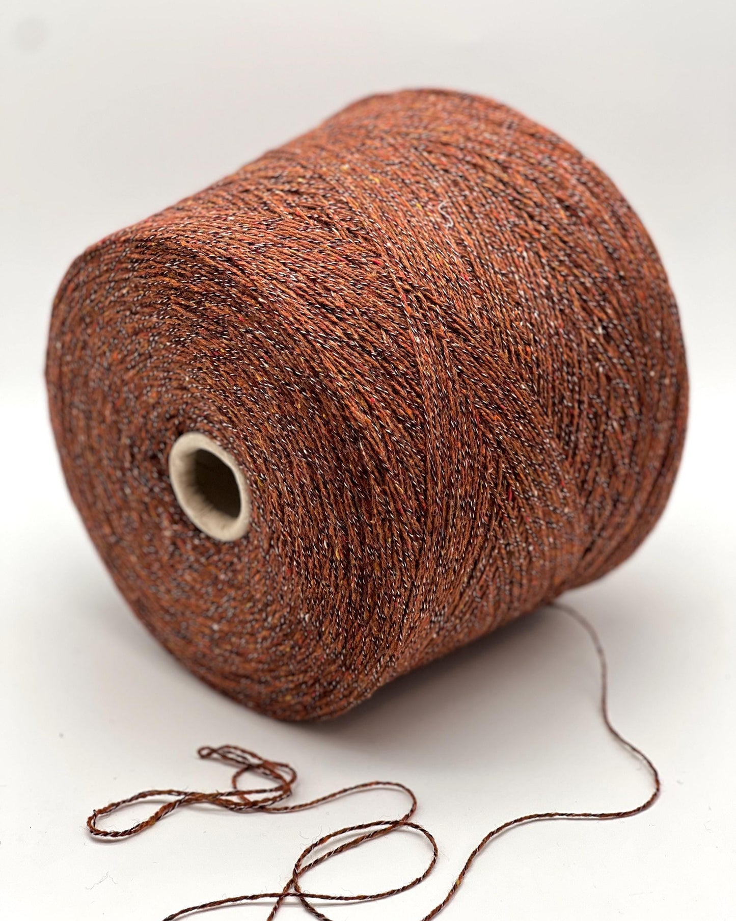 Brown yarn spool on a white background