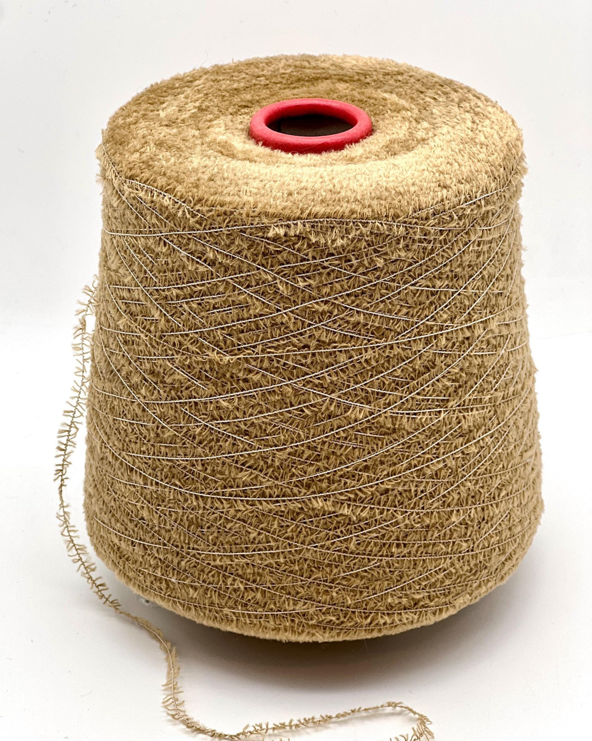 Spool of beige thread on a white background