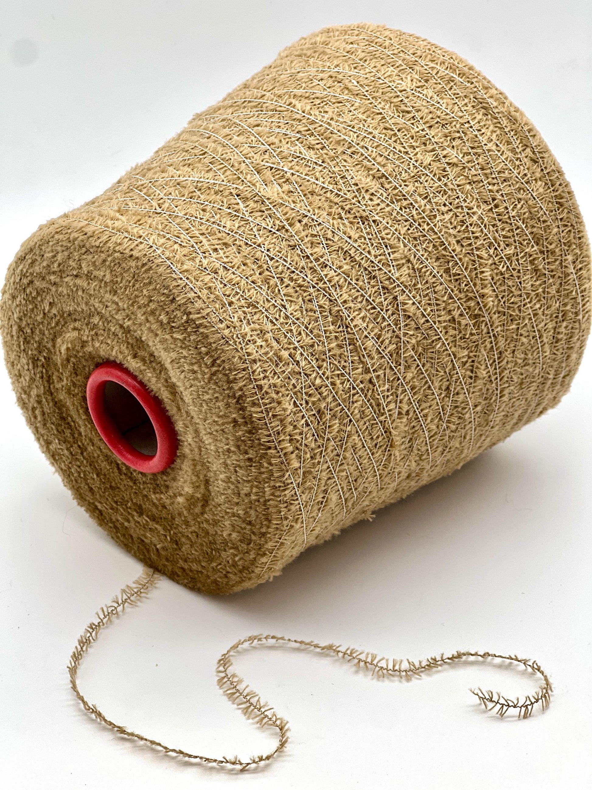 Roll of beige twine with a red core on a white background