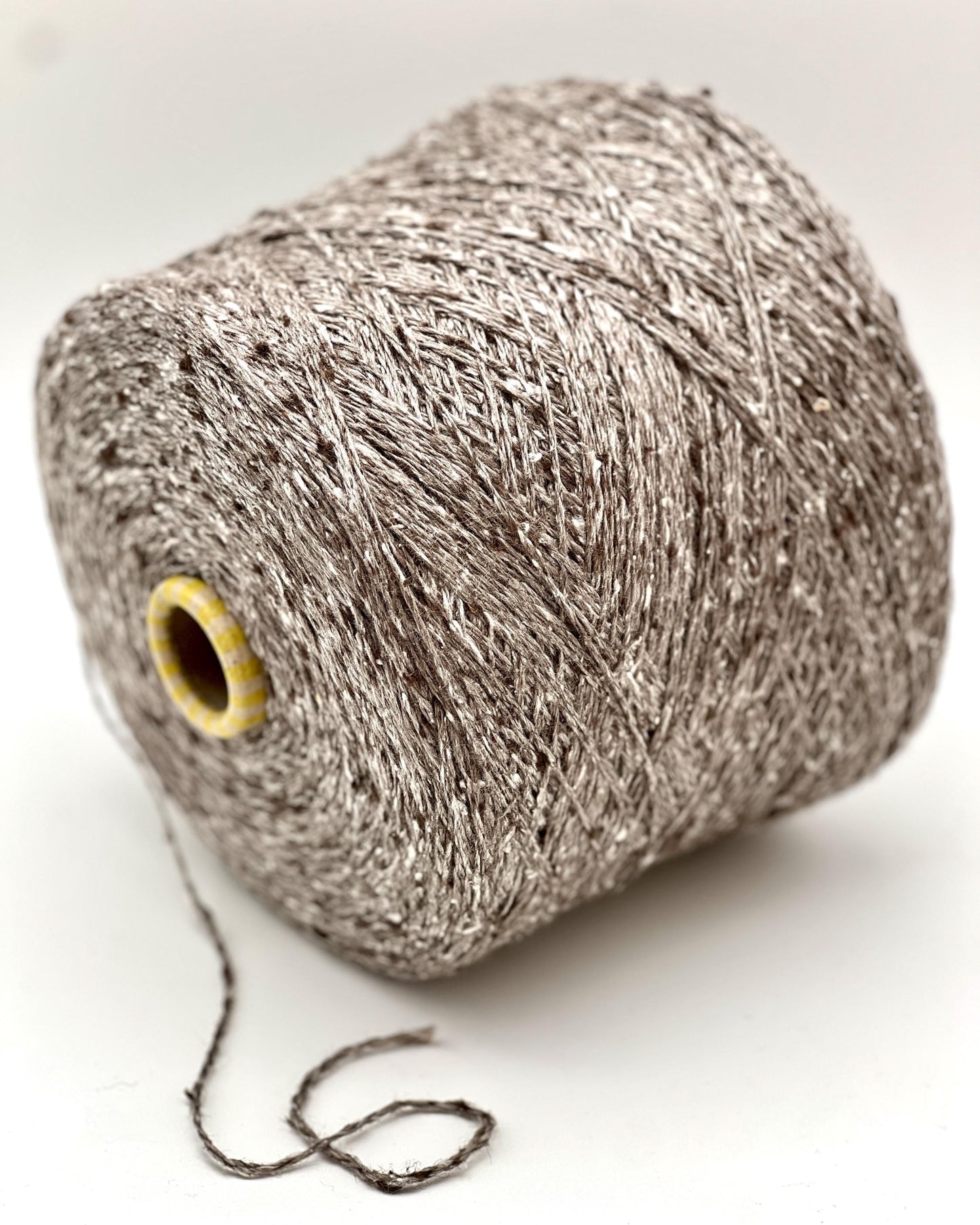 Spool of gray yarn on a white background