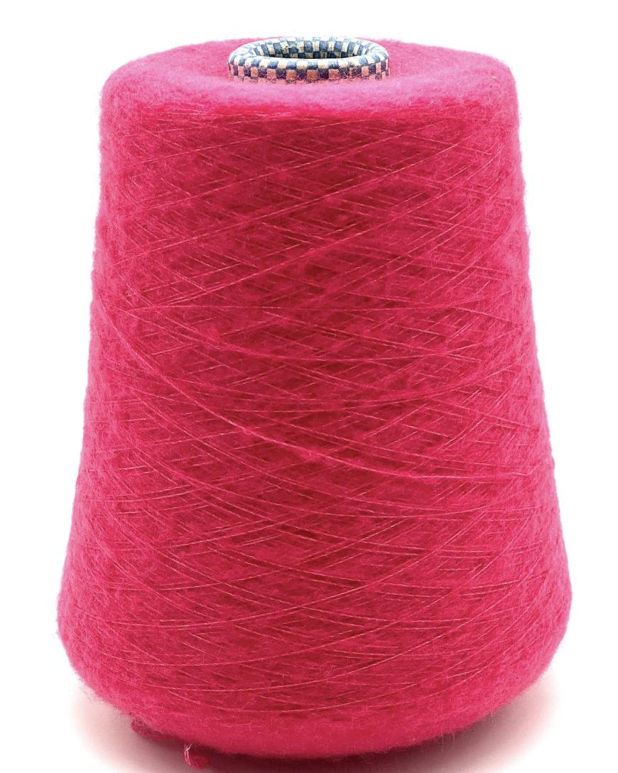 Spool of pink yarn on a white background