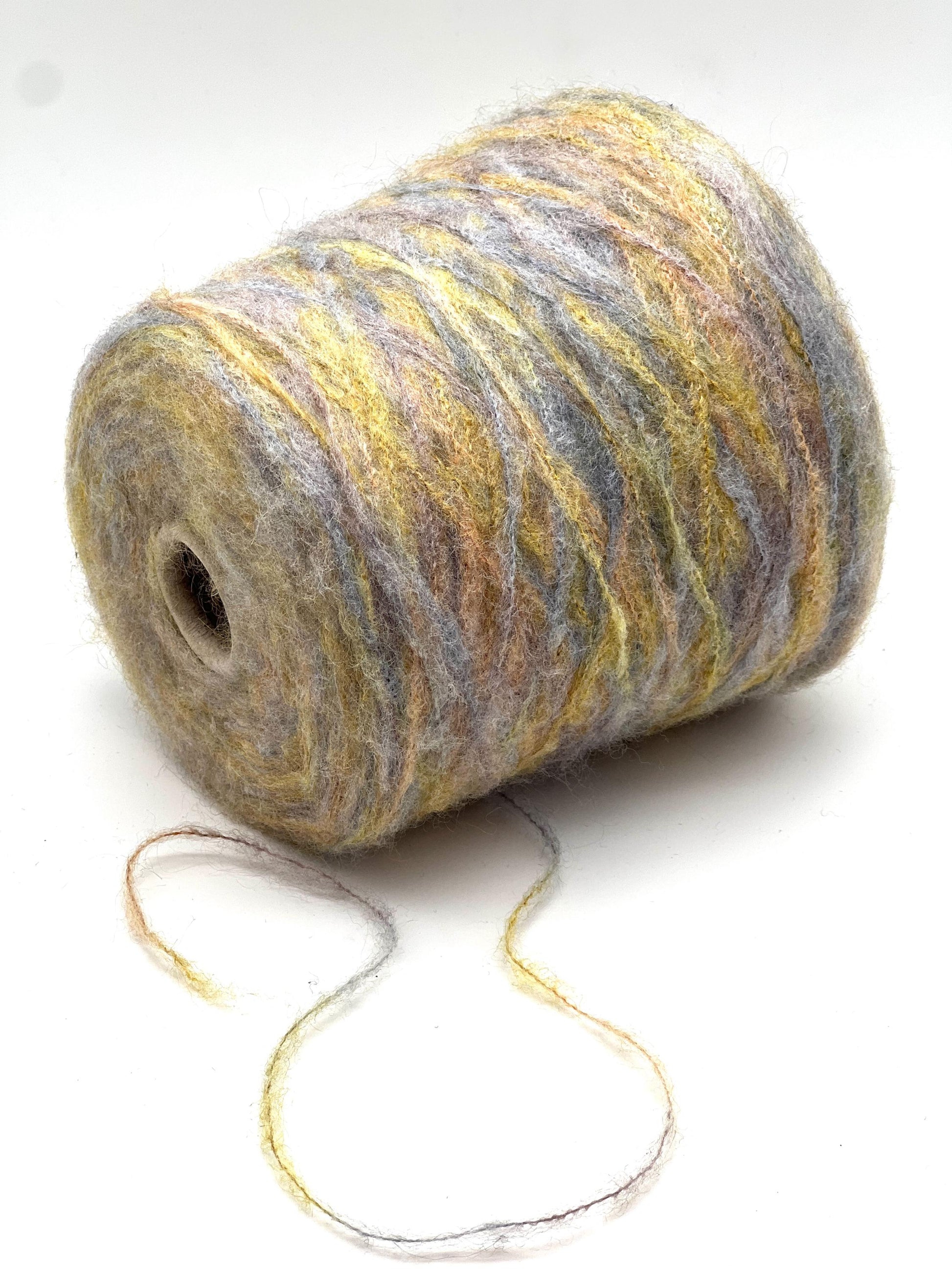 Spool of multicolored yarn on a white background