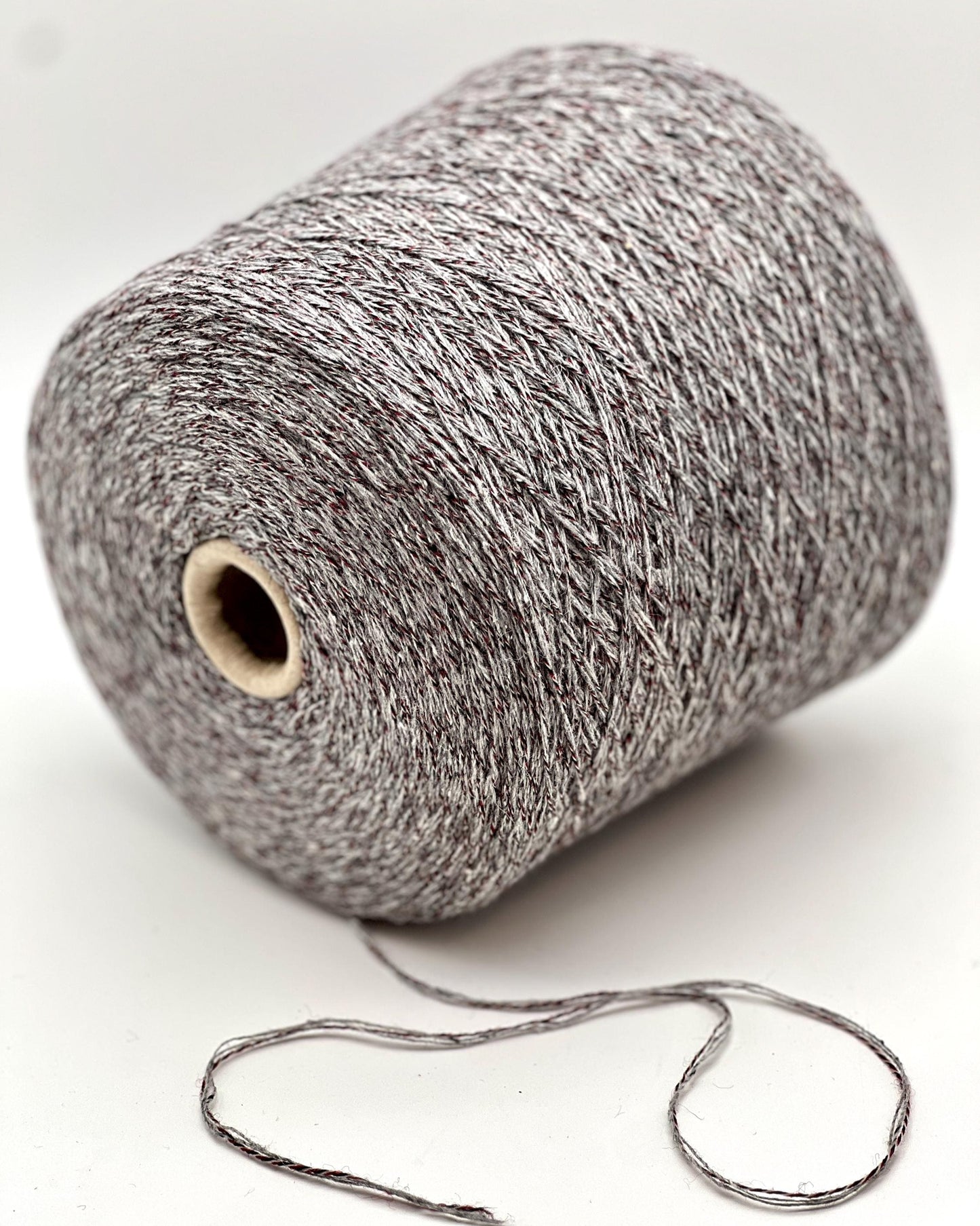 Spool of gray yarn on a white background