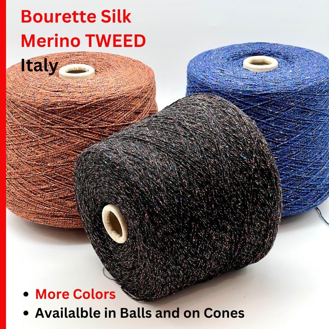 Three spools of Bourette Silk Merino Tweed yarn in brown, black, and blue on a white background.