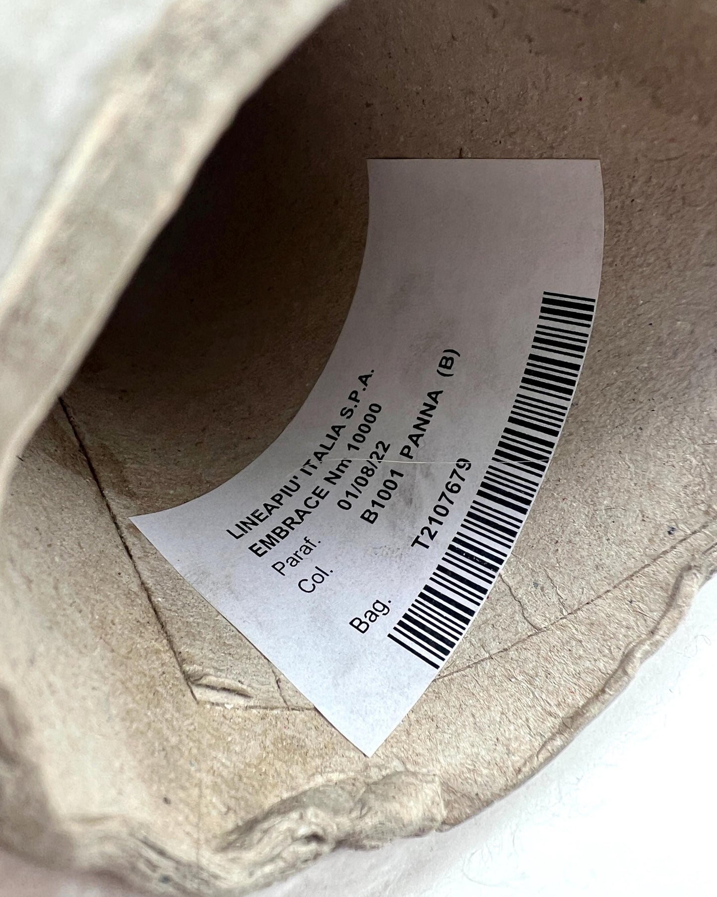 Close-up of a label on a cardboard box with text and a barcode.