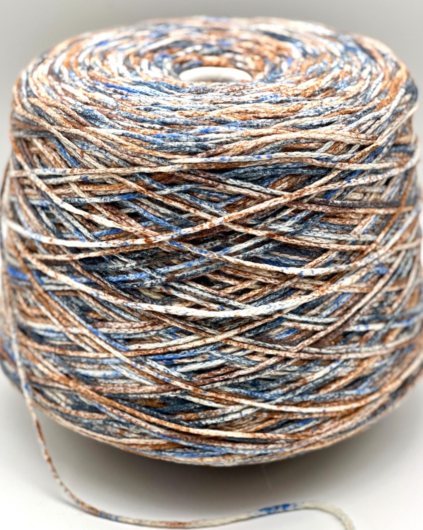 Ball of multicolored yarn on a light background