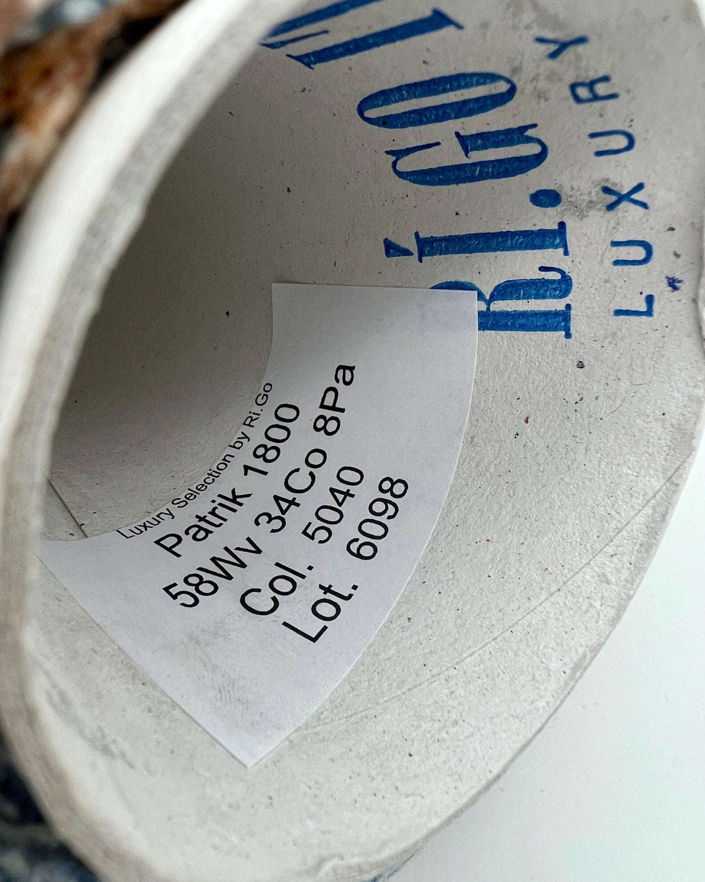 Close-up of a label inside a shoe with text and branding.